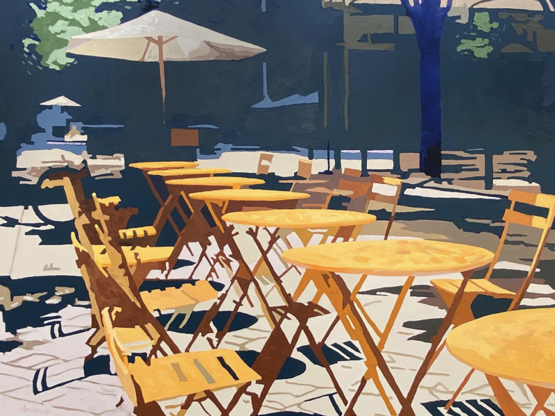 An impressionistic painting by Michael Anderson titled Bistro Tables, measuring 30 x 40 x 0.75 inches. The artwork captures a sunlit outdoor café scene with rows of round yellow bistro tables and matching folding chairs arranged on a patio. Strong, angular shadows cast by the furniture create a dynamic pattern on the ground. In the background, large umbrellas and trees provide shade, with hints of buildings and urban elements adding depth. The painting features a warm, golden palette contrasted with cool blues and deep shadows. The artist's signature is visible in the lower left corner.
